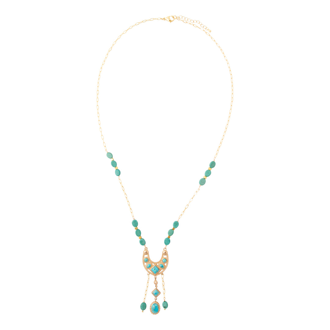 A gold-tone necklace featuring a crescent moon pendant embellished with turquoise-colored stones, flanked by matching turquoise bead drops on a delicate gold chain, set against a plain white background.
