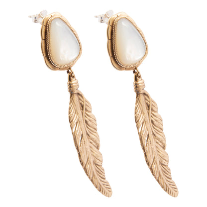 Gold feather earrings with white stones on a white background