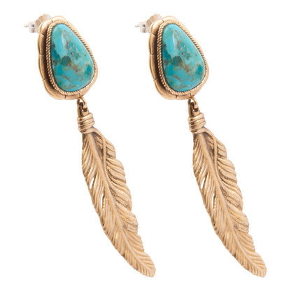 Gold feather-shaped earrings with turquoise stones on a white background