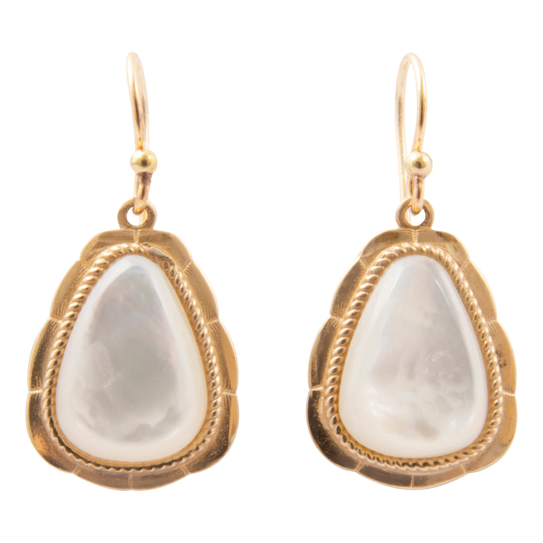 Gold-framed earrings with white stones on a white background