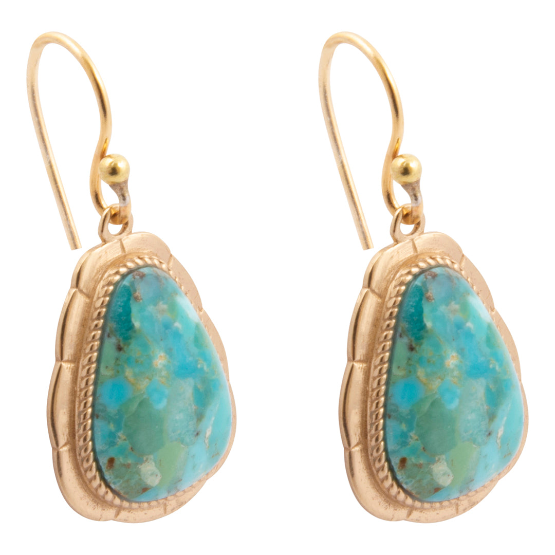 A pair of gold drop earrings with scalloped gold bezel settings holding irregular turquoise-blue marbled stone pendants, shown on a plain white background.