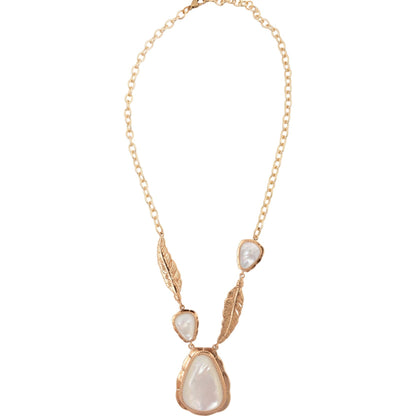 Necklace with gold chain and pearl-like pendants on a white background
