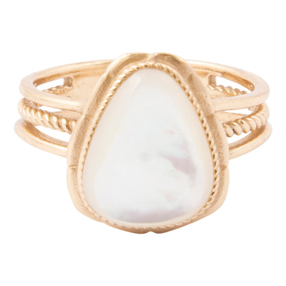 Gold ring with a large white stone on a white background