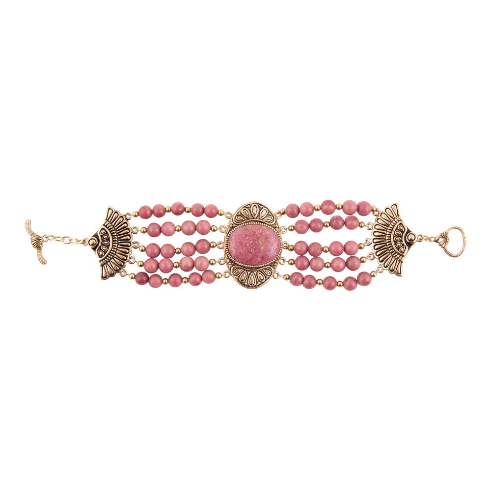 A bohemian-style multi-strand beaded bracelet featuring pink stone beads, ornate antique bronze metal filigree details, and a central oval pink stone, shown on a plain white background.