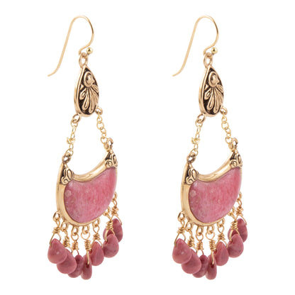 A pair of gold and pink drop earrings featuring a crescent-shaped pink stone in an ornate gold frame, with dangling pink beads at the bottom, shown on a plain white background.