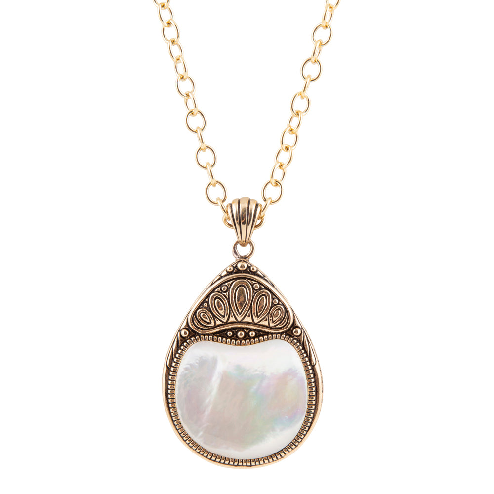 A gold chain necklace with a teardrop-shaped pendant featuring an iridescent white mother-of-pearl center and ornate gold filigree detailing at the top, shown against a plain white background.