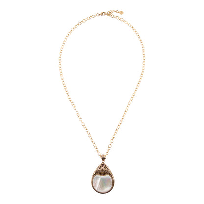 A delicate gold chain necklace featuring a teardrop-shaped pendant with a white mother-of-pearl center and ornate gold filigree detailing at the top, shown against a plain white background.