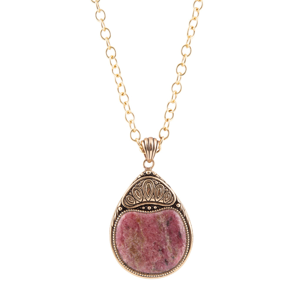 A gold chain necklace with a teardrop-shaped pendant featuring a pinkish-purple stone in an ornate gold and silver-toned bezel setting, shown against a plain white background.