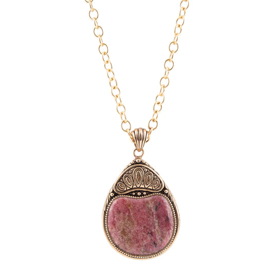 A gold chain necklace with a teardrop-shaped pendant featuring a pinkish-purple stone in an ornate gold and silver-toned bezel setting, shown against a plain white background.