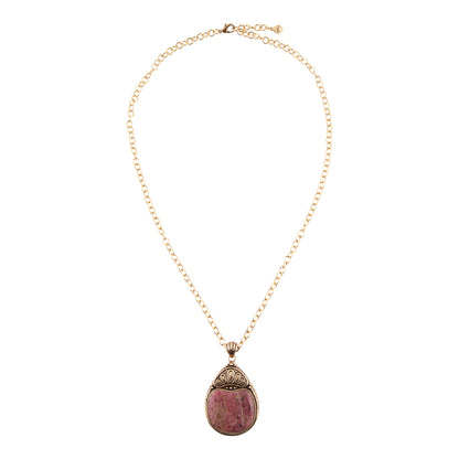 A gold chain necklace with a teardrop-shaped pendant featuring a pinkish-purple stone and ornate gold-toned metal detailing, shown against a plain white background.