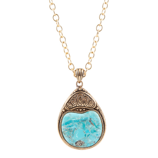 A gold-tone chain necklace with an ornate teardrop pendant featuring a light blue turquoise stone in a textured, antique-style gold bezel setting, shown against a plain white background.