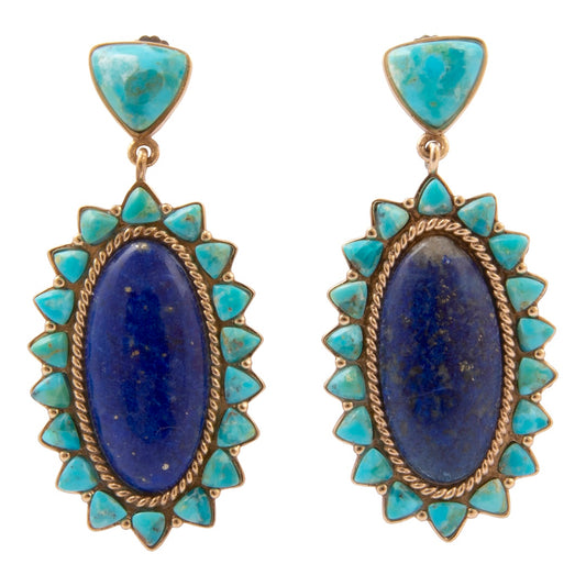 Pair of earrings with blue stones and turquoise accents on a white background