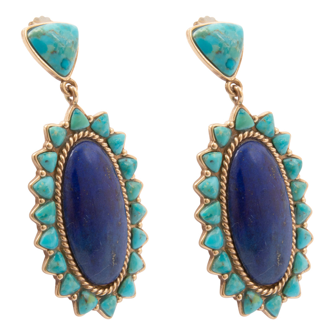 Pair of earrings with blue stones and turquoise accents on a white background