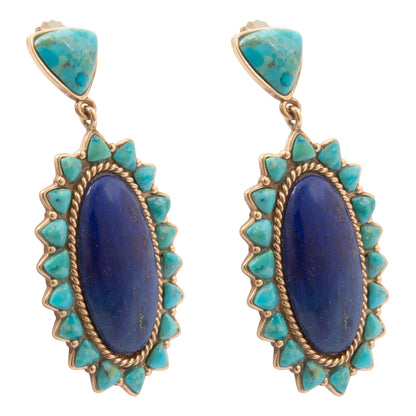 Pair of earrings with blue stones and turquoise accents on a white background