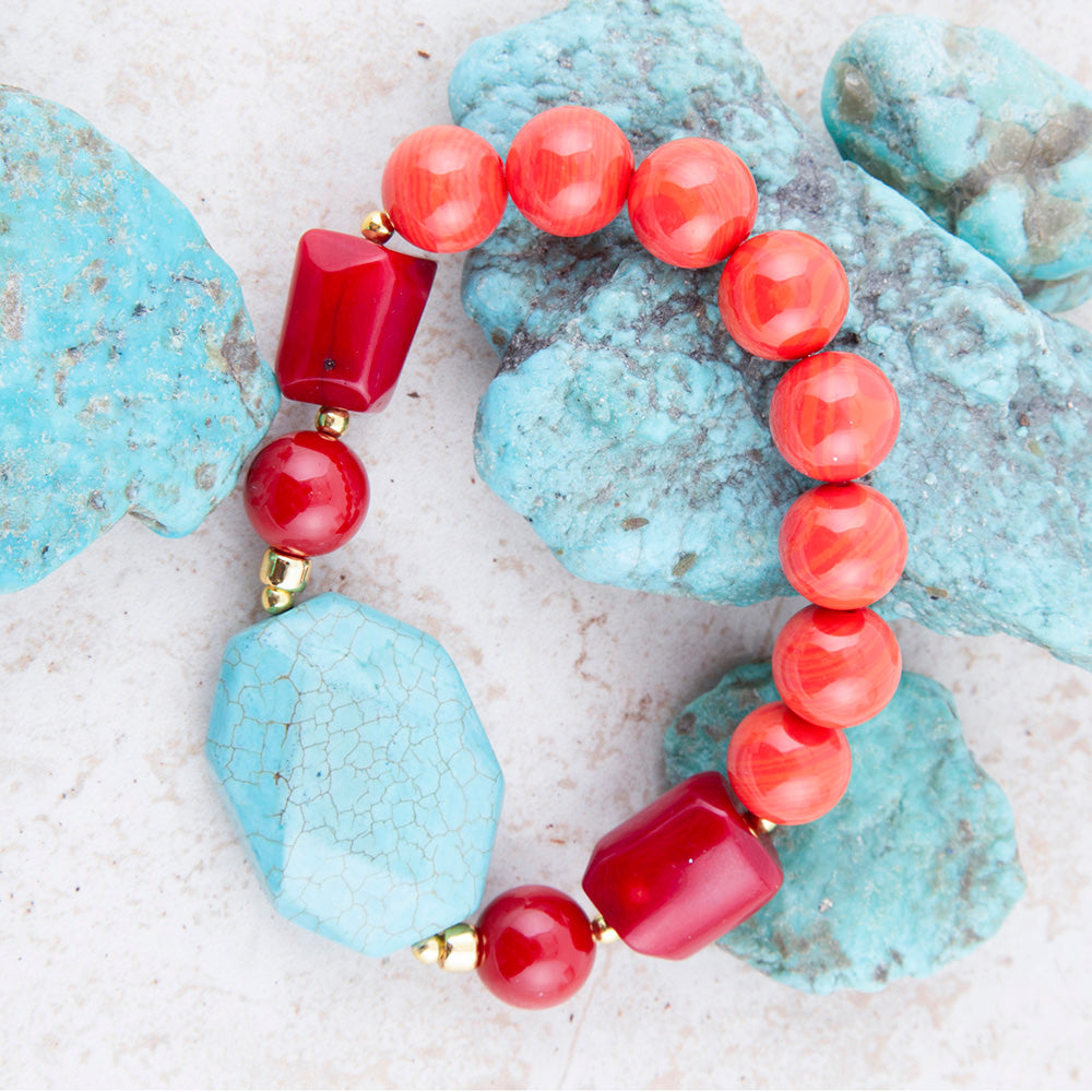 Bracelet with coral and turquoise beads on a textured surface