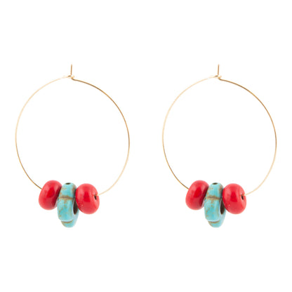 Gold hoop earrings with red and turquoise beads on a white background