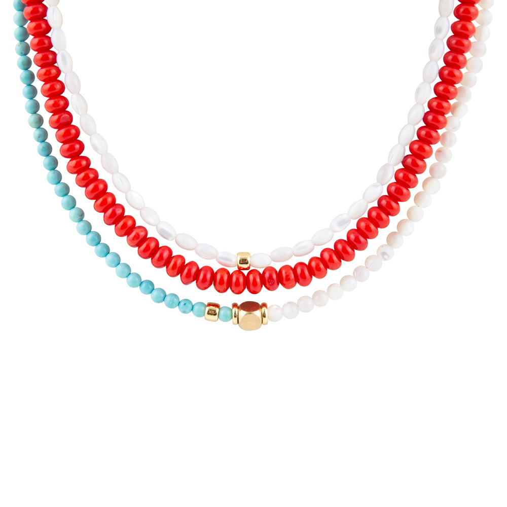 Three beaded necklaces in red, white, and turquoise on a white background