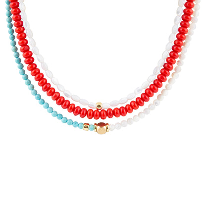 Three beaded necklaces in red, white, and turquoise on a white background