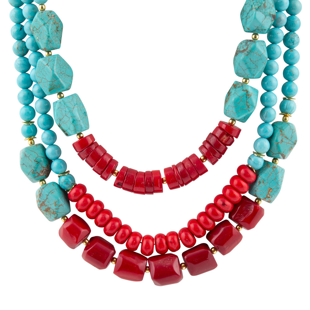 Necklace with turquoise and red beads on a white background