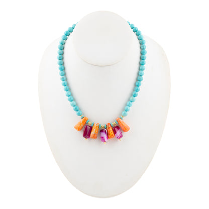 Necklace with colorful beads on a white stand
