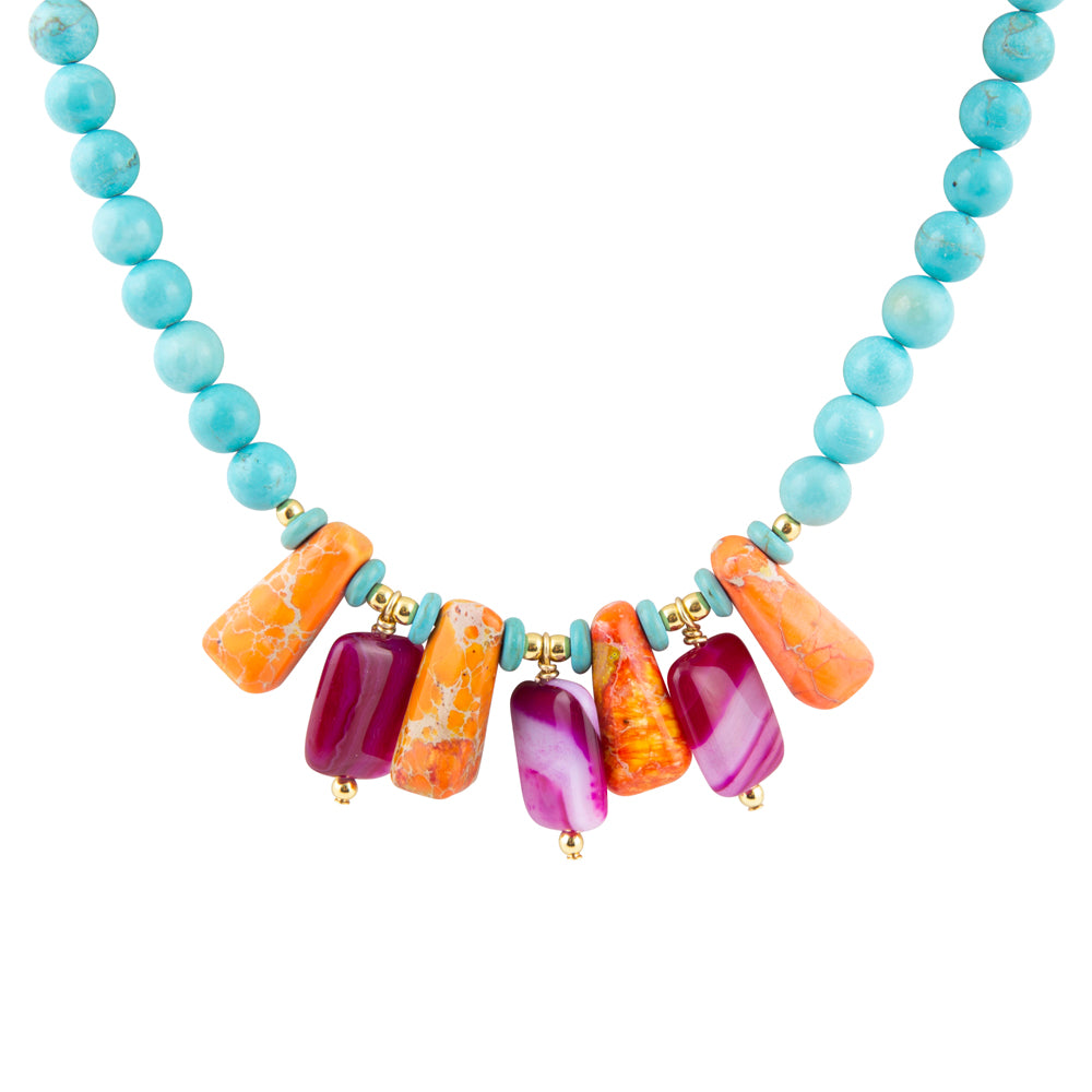 Necklace with turquoise beads and colorful rectangular beads on a white background