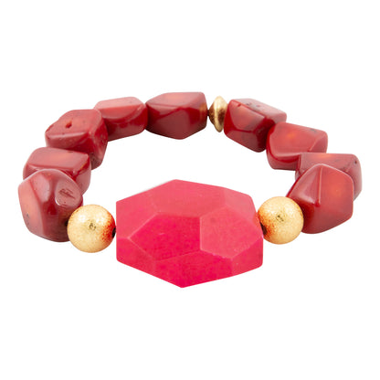 Bracelet with red geometric beads and gold accents on a white background