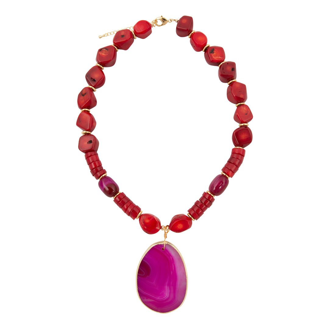 Necklace with red beads and a large purple pendant on a white background