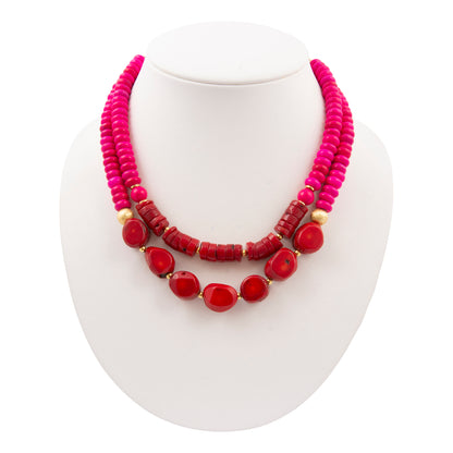 Necklace with pink and red beads on a white background