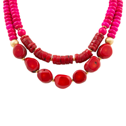 Two necklaces with red and pink beads on a white background