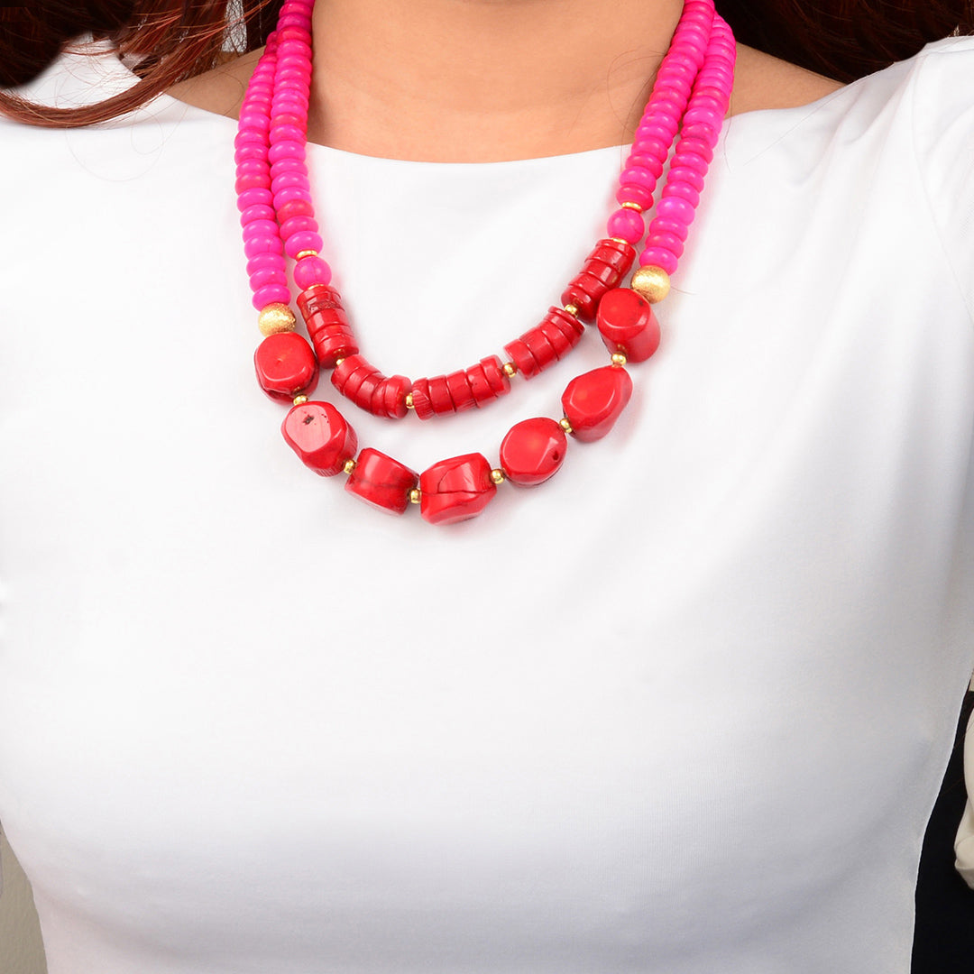 Necklace with pink and red beads on a white background