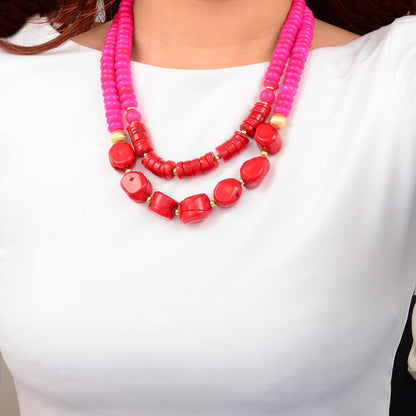 Necklace with pink and red beads on a white background