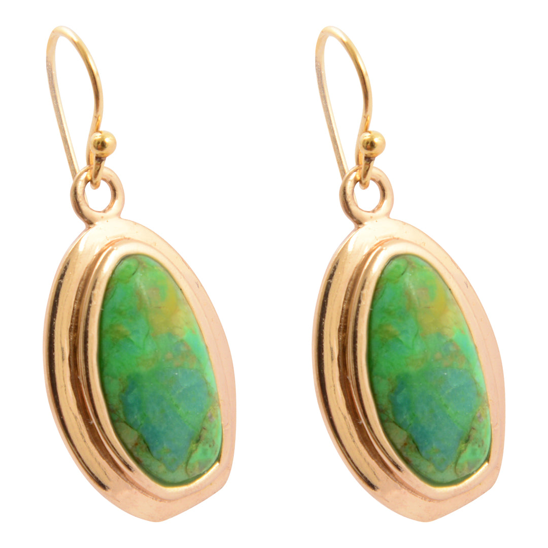 Gold earrings with green stone on a white background