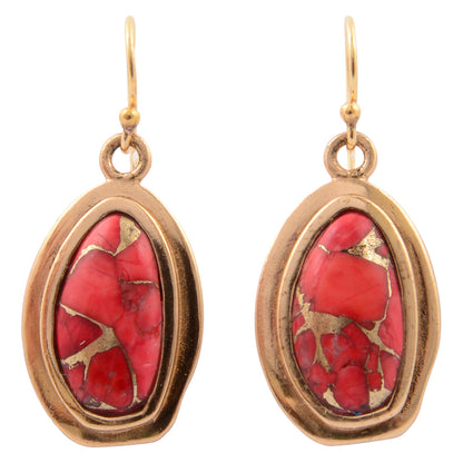 Gold-framed earrings with red gemstones on a white background