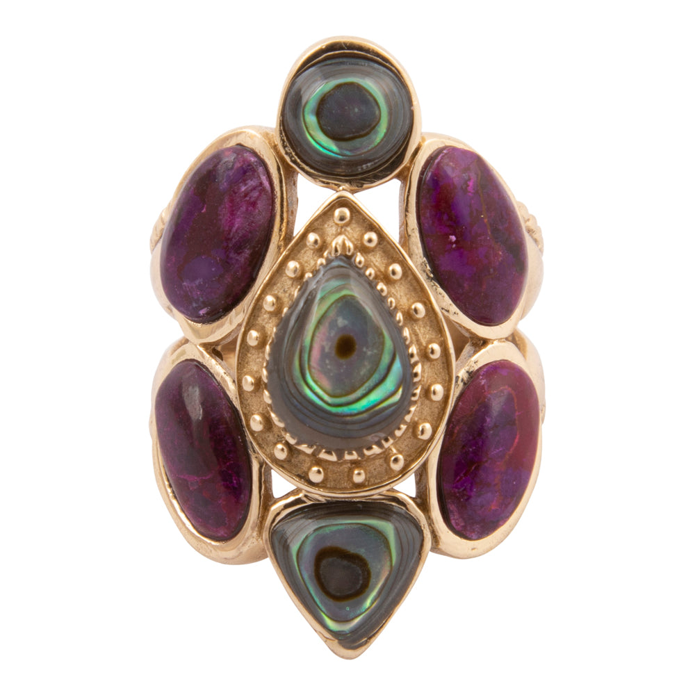 Gold ring with purple and green gemstones on a white background