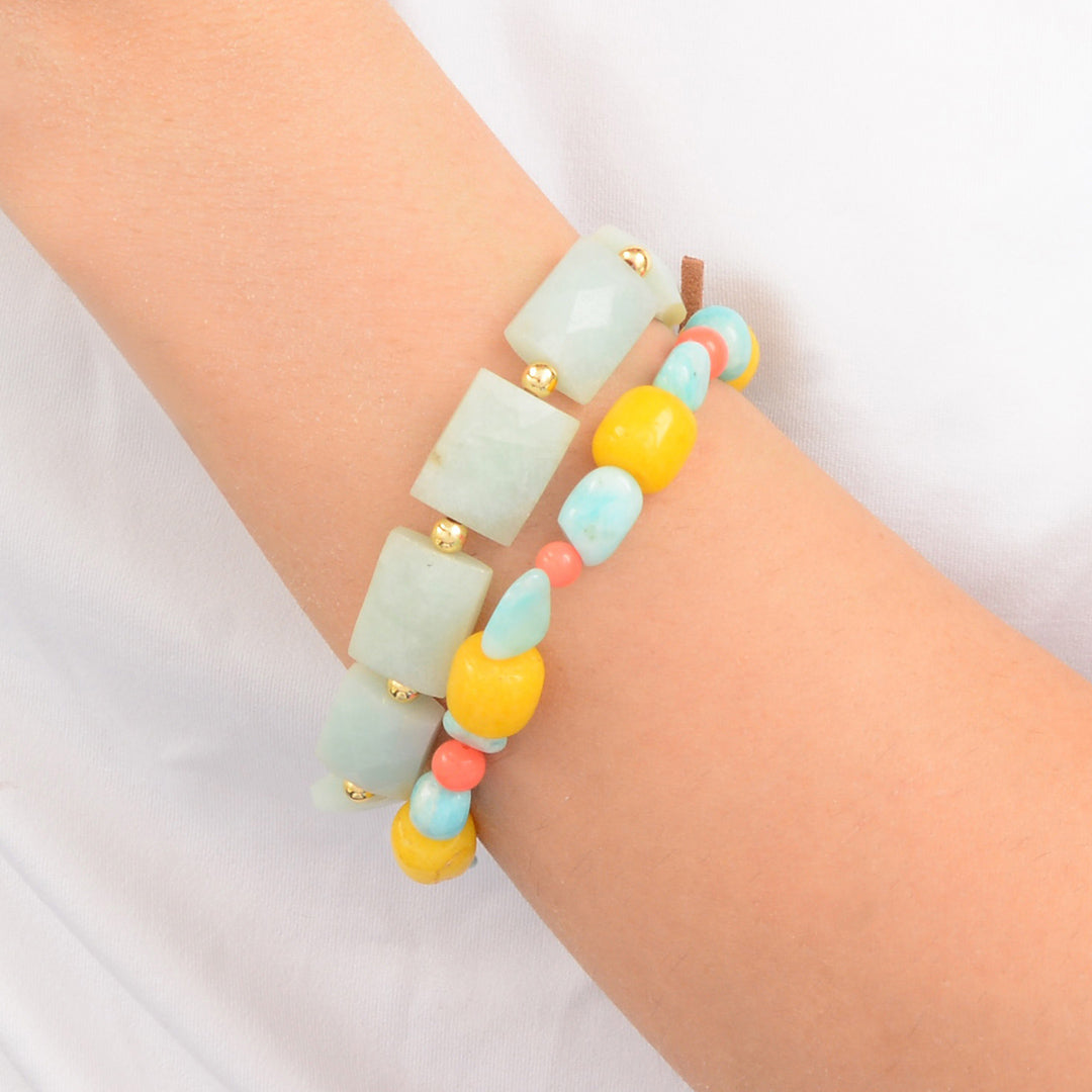 Colorful beaded bracelet on a wrist against a white background