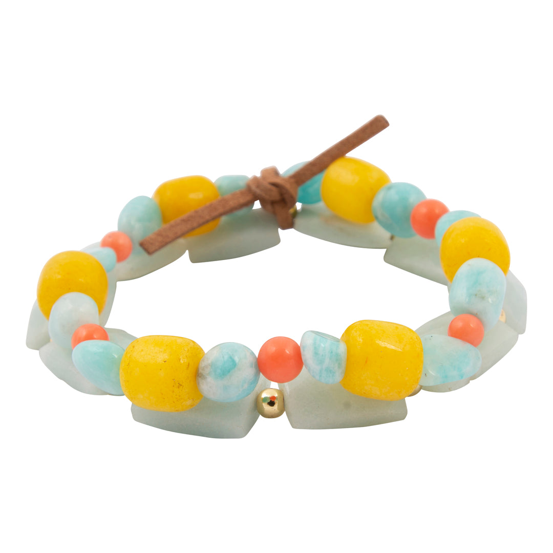 Colorful beaded bracelet with a wooden stick on a white background