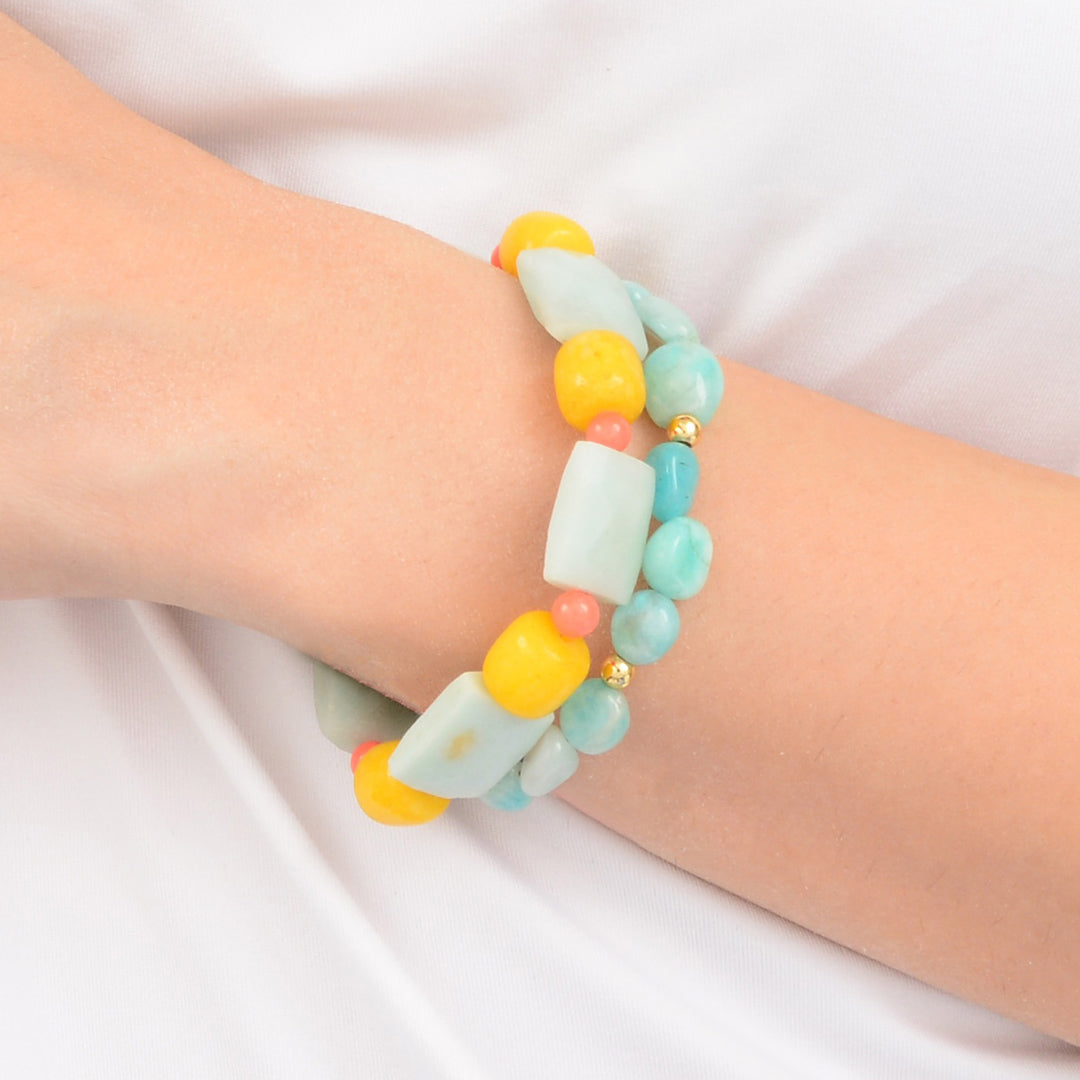 Colorful beaded bracelet on a wrist against a white background