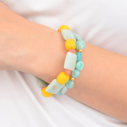 Colorful beaded bracelet on a wrist against a white background