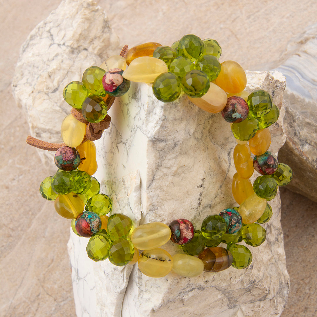 Multicolored beaded bracelet on a textured stone surface