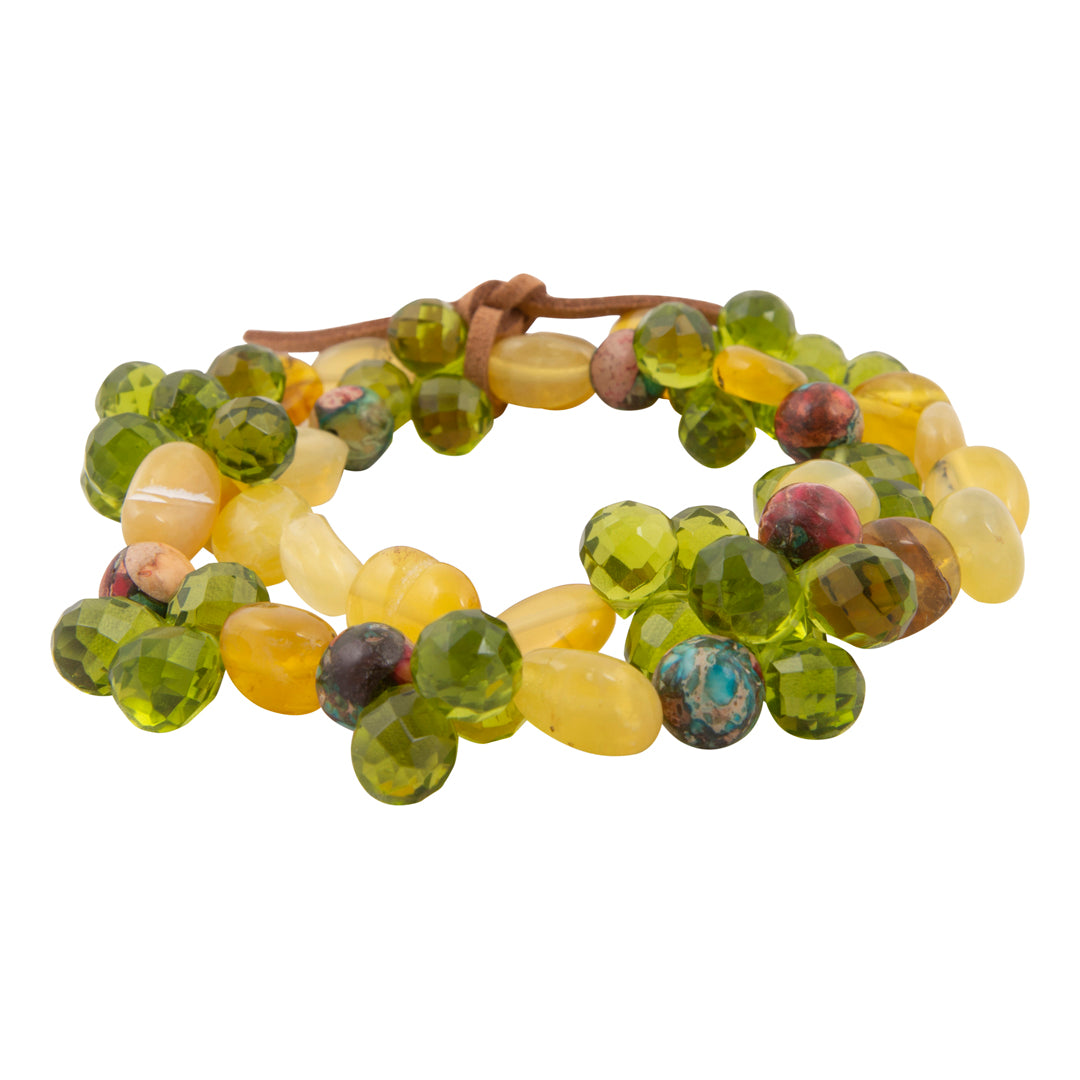 Beaded bracelet with green and yellow beads on a white background