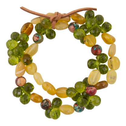 Beaded wreath with green, yellow, and brown beads on a white background