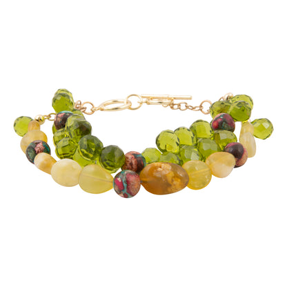 Beaded bracelet with green and yellow beads on a white background