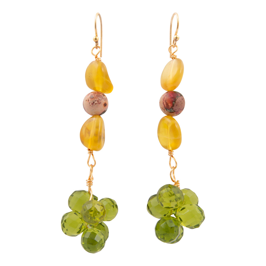 Pair of earrings with yellow and green beads on a white background