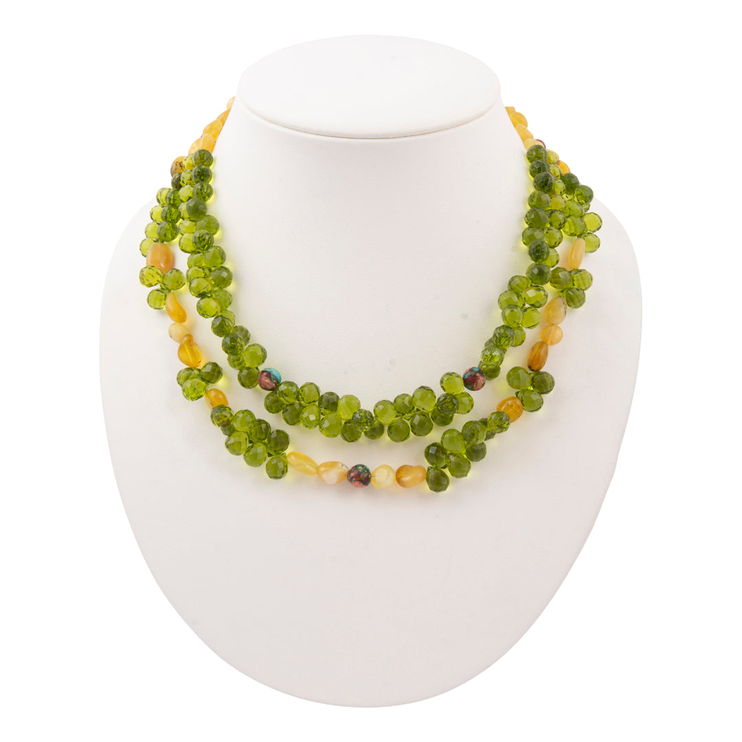 Green beaded necklace on a white mannequin bust