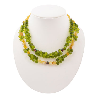 Green beaded necklace on a white mannequin bust