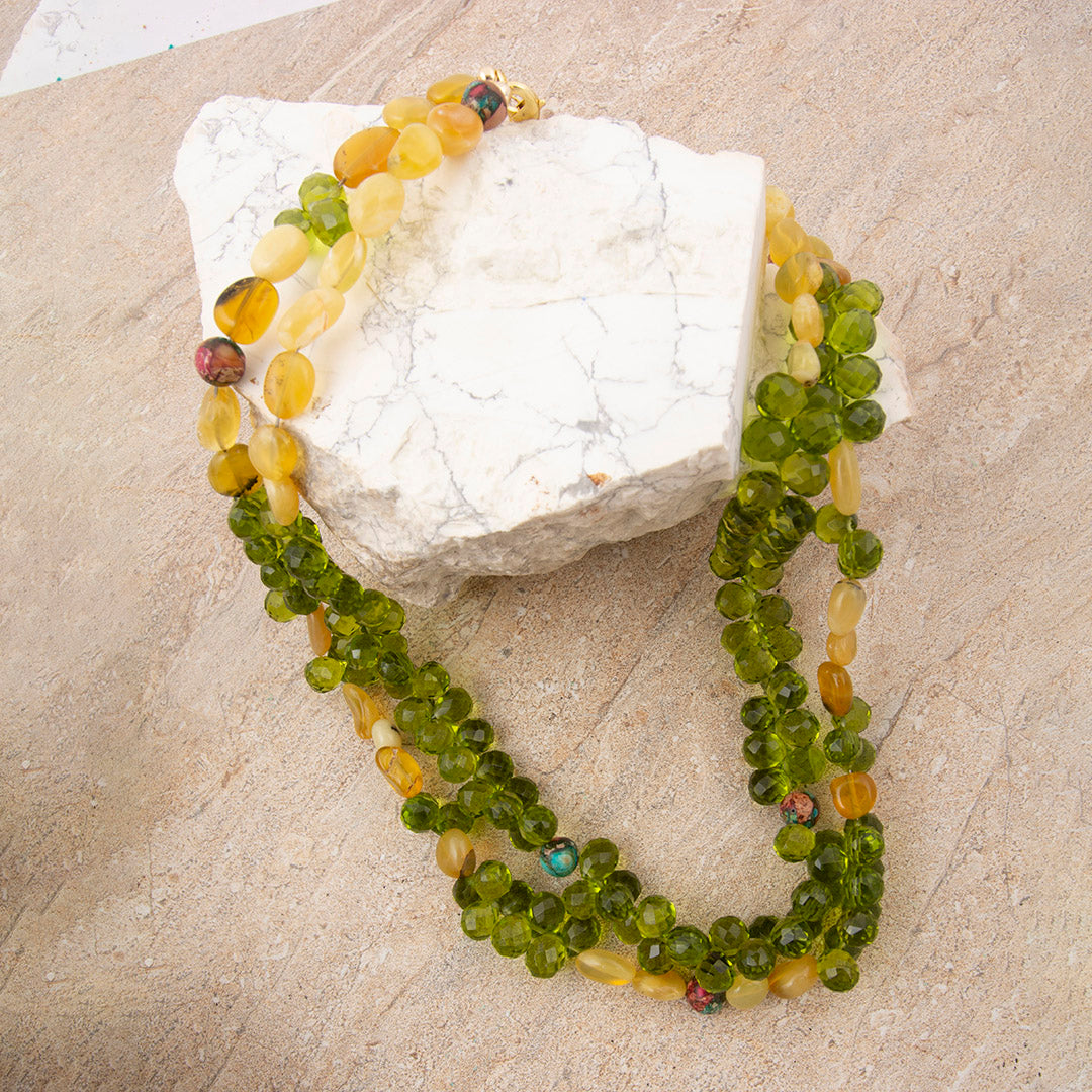 Beaded necklace with multicolored beads on a stone surface