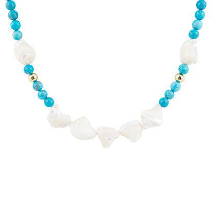 A beaded necklace featuring light blue round beads, irregular white baroque shell beads, and small metallic gold spacer beads, displayed on a clean white background.