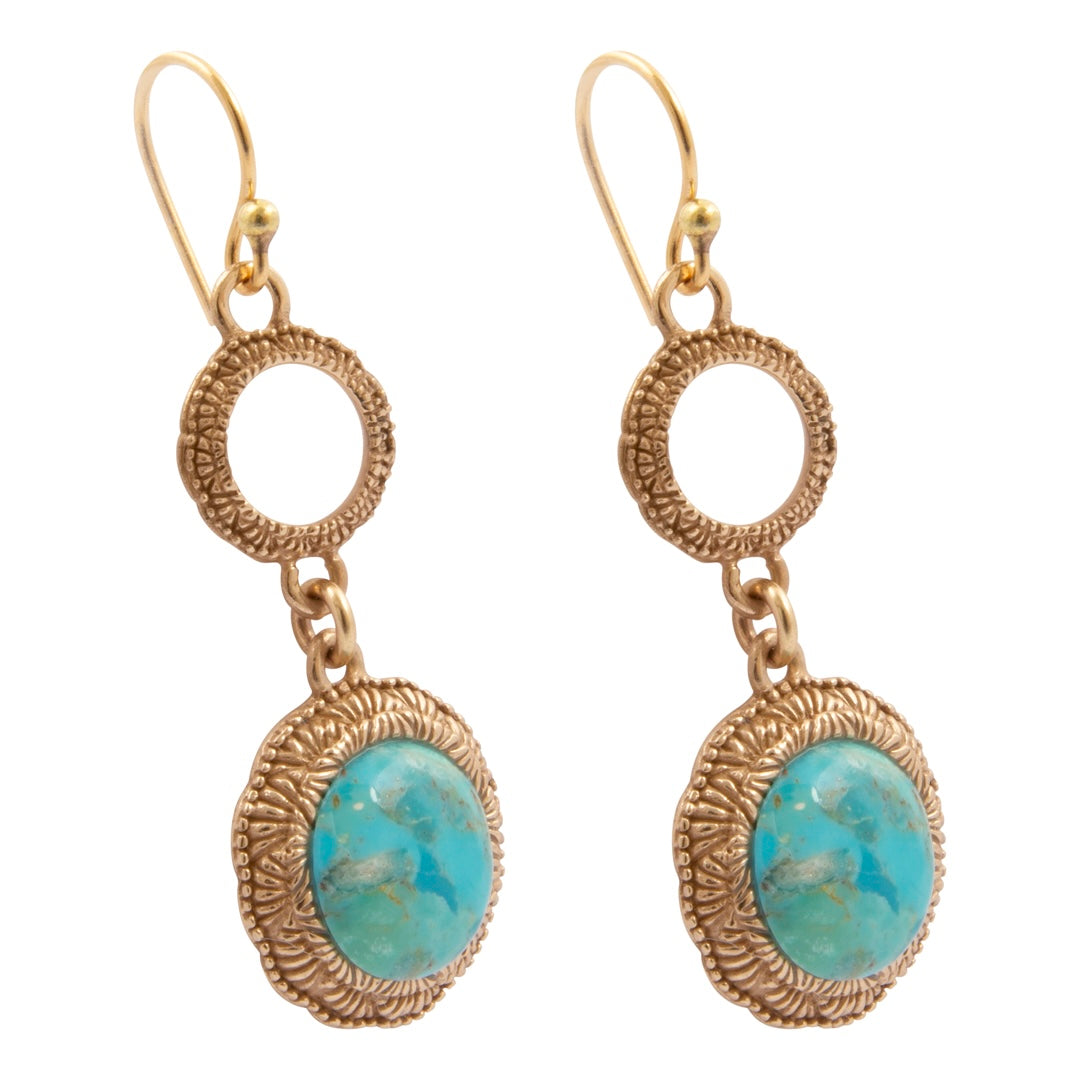 A pair of gold drop earrings featuring textured circular rings and oval turquoise cabochon stones, shown against a plain white background.