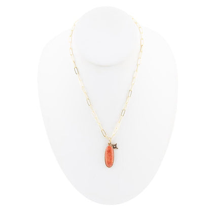 Necklace with a pink pendant on a white background