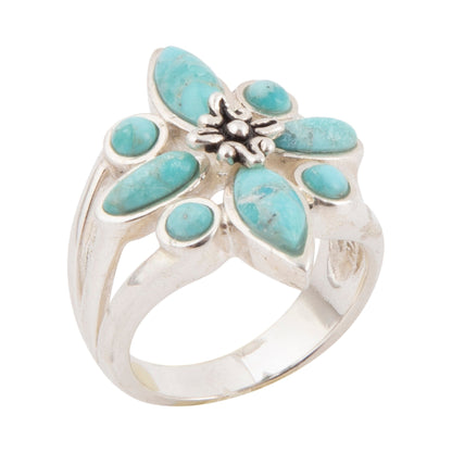 Silver ring with turquoise stones on a white background